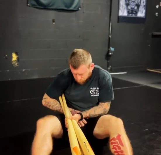 This is why you tap immediately. A BJJ practitioner demonstrating the breaking mechanics of an ankle lock on 3 baseball bats