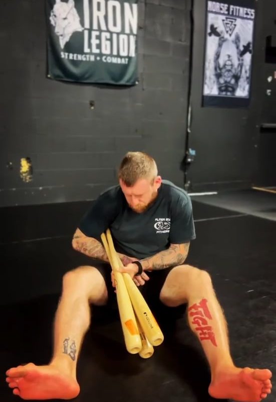 This is why you tap immediately. A BJJ practitioner demonstrating the breaking mechanics of an ankle lock on 3 baseball bats