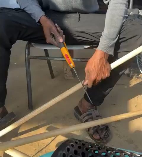 A man makes a home made washing machine from the materials available to him