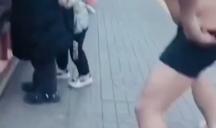 A man quickly removes his clothes and jumps into freezing water to rescue a stranger.