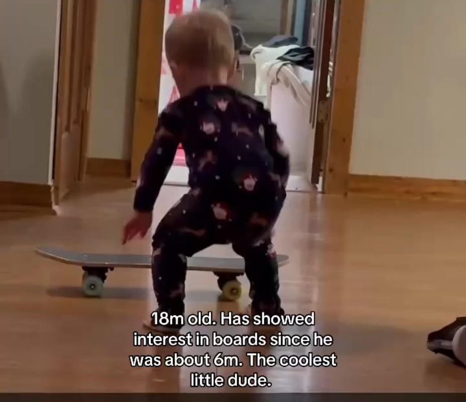 An 18 month old on a skateboard