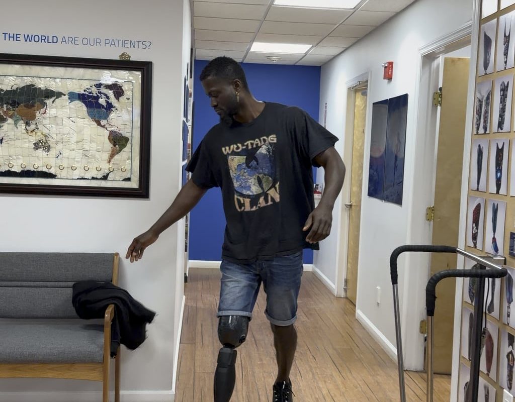 An amputee walking with a very technological improved prosthetic.