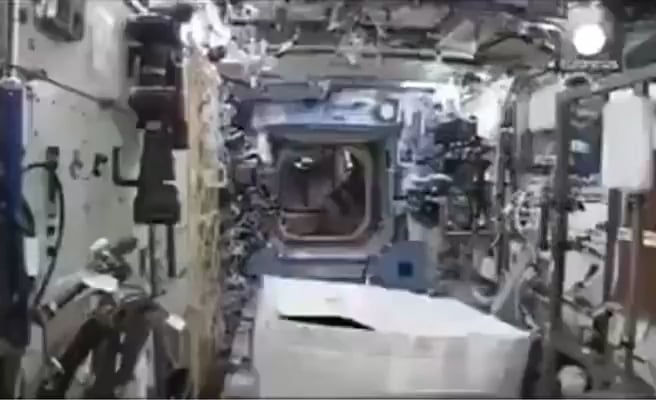 Astronaut Mark Kelly putting on a gorilla suit he smuggled into the ISS to prank his crewmates