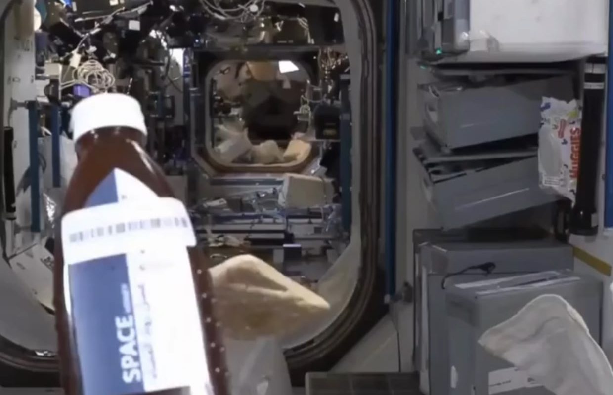 Astronaut eating bread and honey in space