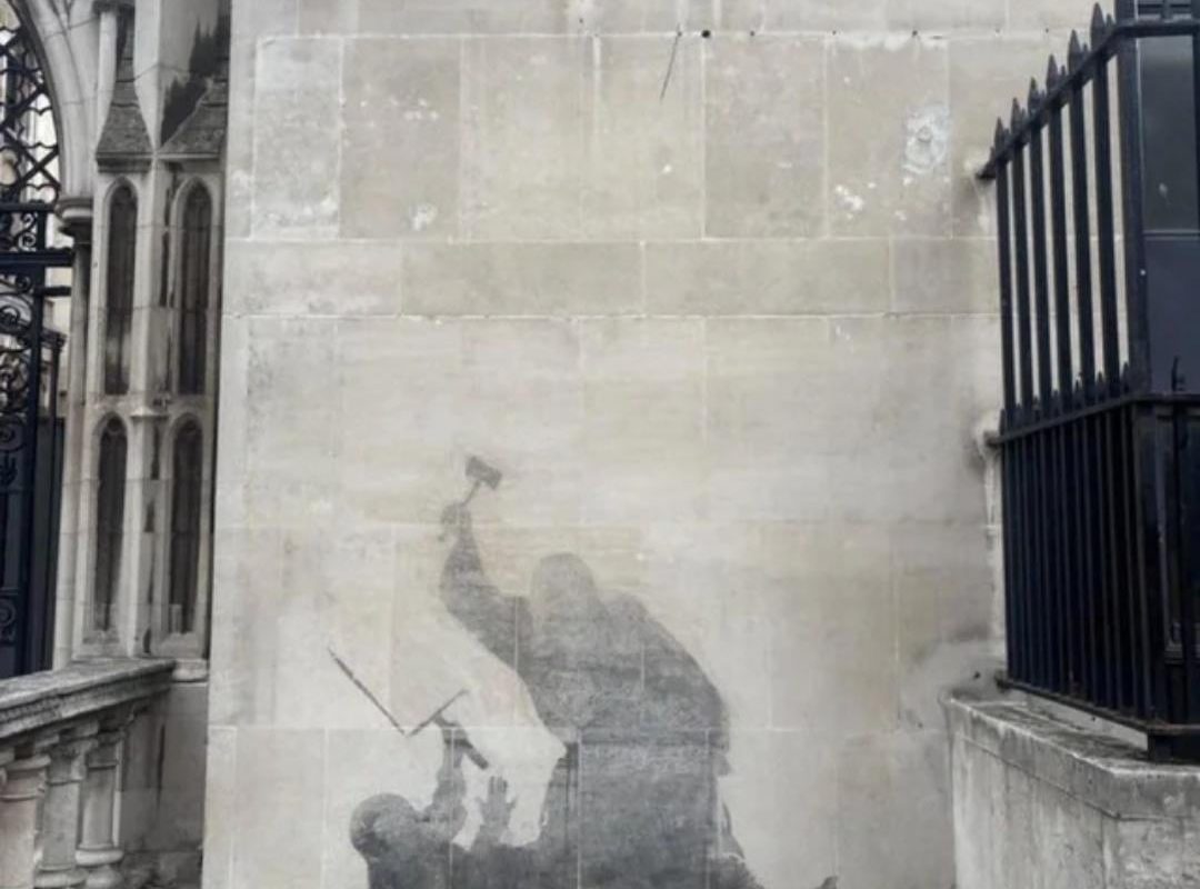 Banksy's latest mural, a judge striking a protester with a gavel, was washed off a day after appearing