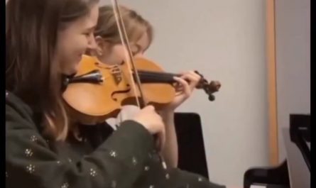Both girls are playing both instruments at the same time