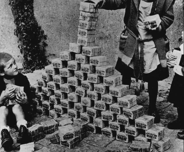 German children playing with stacks of worthless money during the height of hyperinflation in 1923.