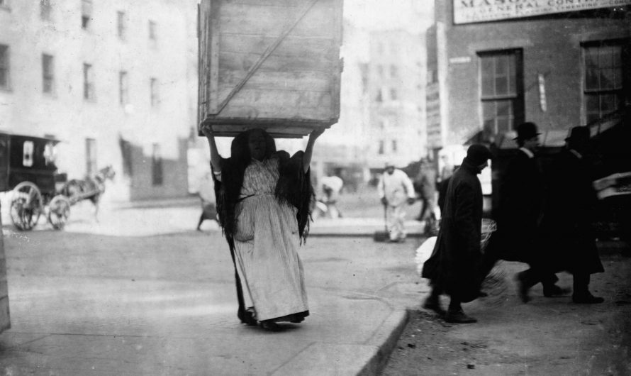 Italian woman carring box of dry goods in New York, February of 1912. Photo by Lewis Hine.