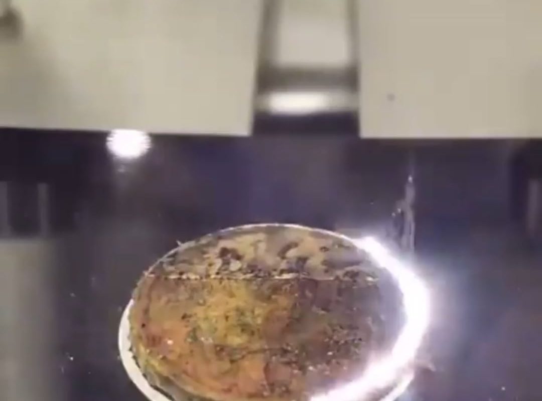 Laser cleaning a coin allows the removal of the thin surface layer containing grime and dirt with a fiber laser.