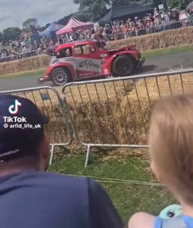 Man casually hops out of a drifting car to greet people