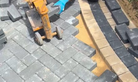 Man cuts and places blocks precisely around a circle