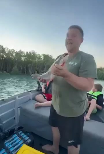 Man notices an Eagle eyeing the fish he just caught.