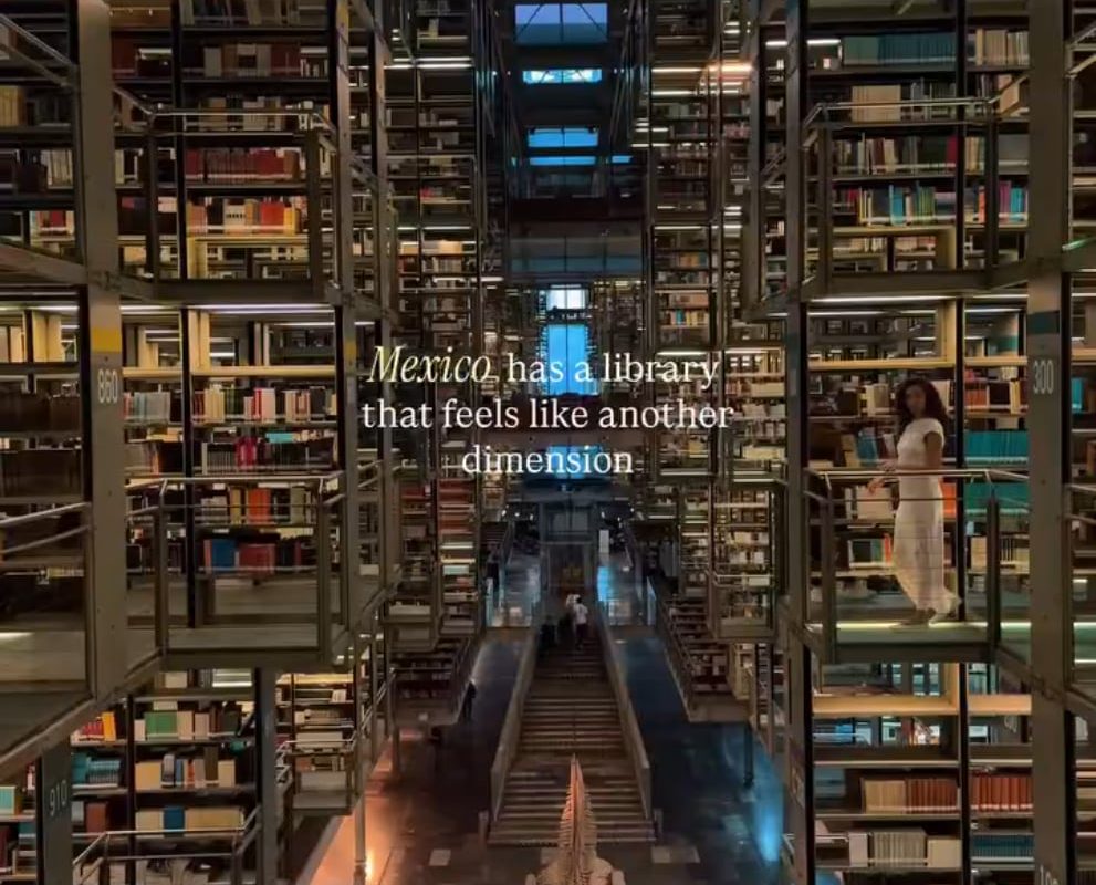 Multi-level interior of Biblioteca Vasconcelos in Mexico showing suspended book shelves, skybridge walkways, and open atrium layout.