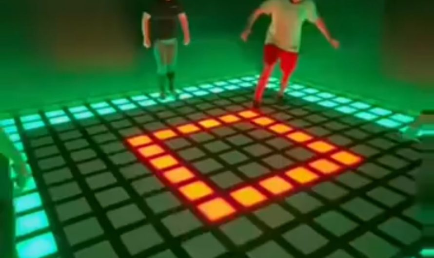 Players work together in lighted floor game