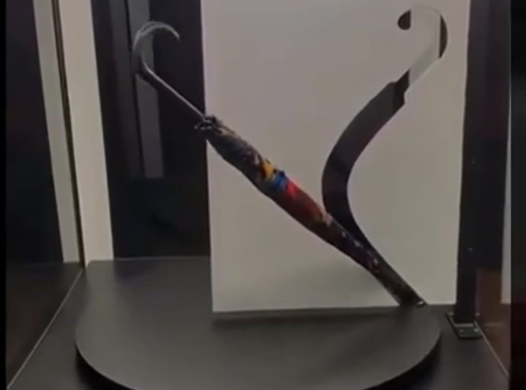 Straight umbrella passes through a curved opening.