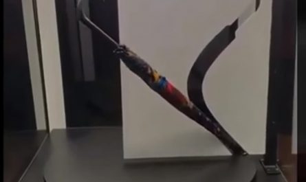 Straight umbrella passes through a curved opening.