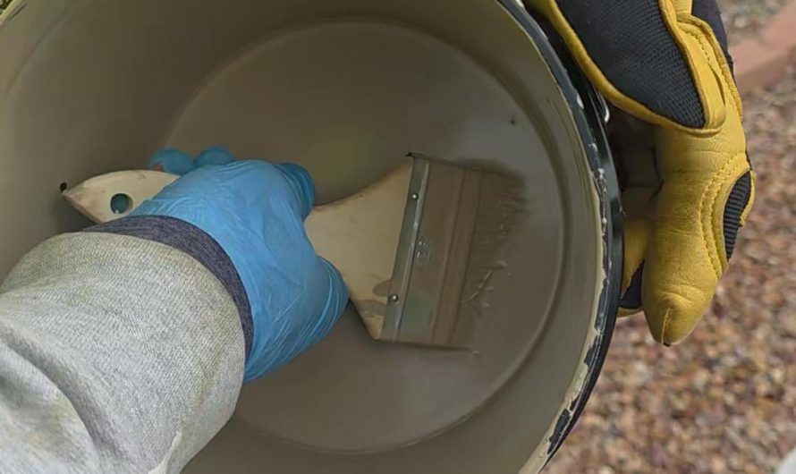 Taking out paint brush from a paint bucket