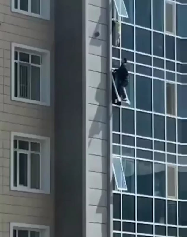 The man climbed out of his eighth floor apartment window to catch the helpless three-year-old girl.