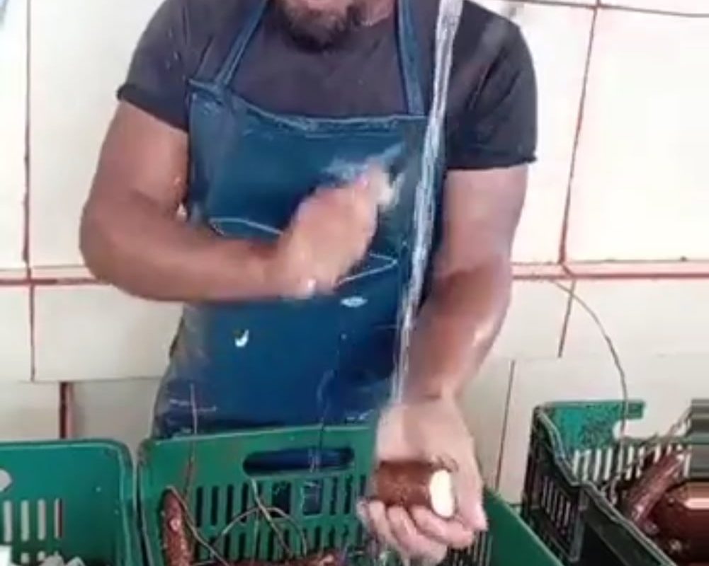 This man peeling cassava.
