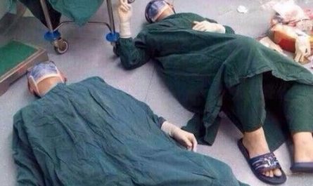 Two surgeons collapse on the floor from exhaustion after a 32-hour surgery to save a life by removing a patient's brain tumors.