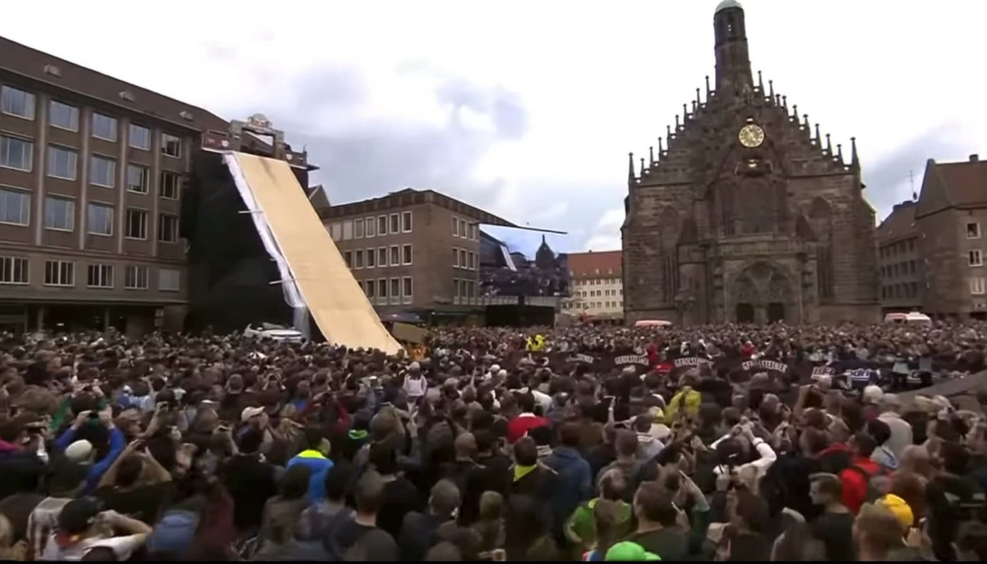 cyclist flips through the air on a bike and sticks the landing.
