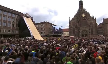 cyclist flips through the air on a bike and sticks the landing.