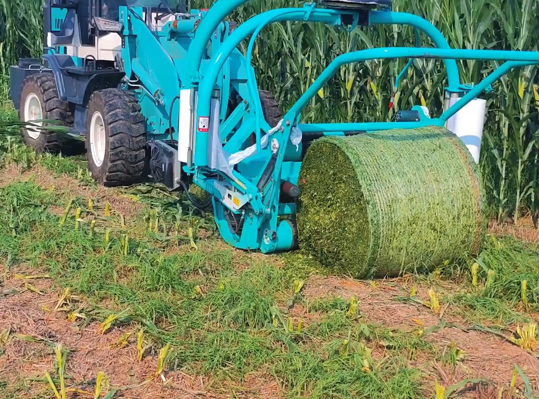 wrapping chopped grass into a big plastic bale