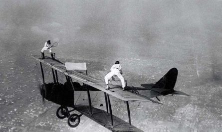 1925 pic of a Promotional Tennis Match atop the wing of a Plane