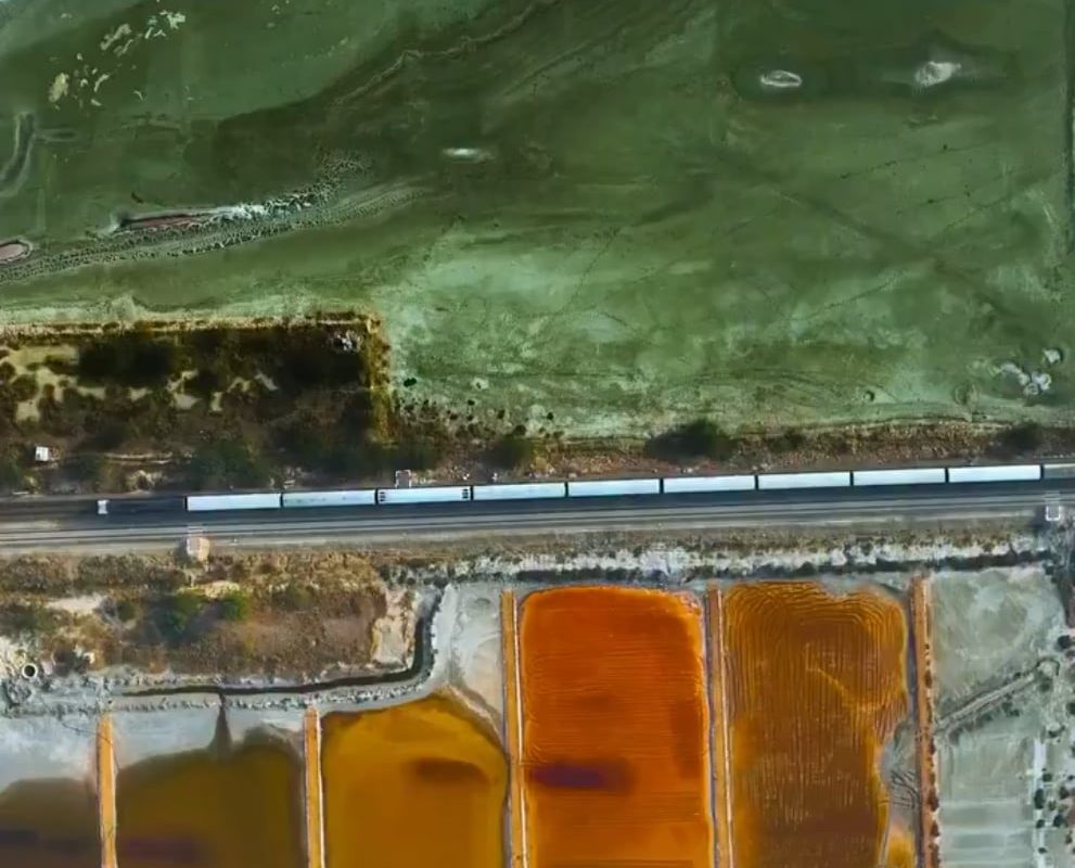 A Train passing through the salt extraction area of sambhar Lake in the Indian state of Rajasthan