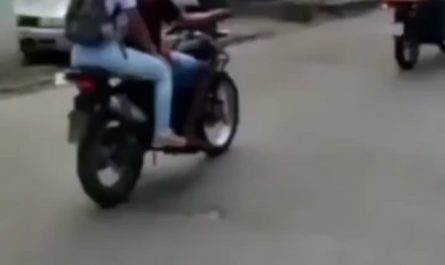 A biker balancing a tray of fruit salad for delivery