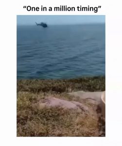 A helicopter pilot decided to pose for a photo with a random guy.