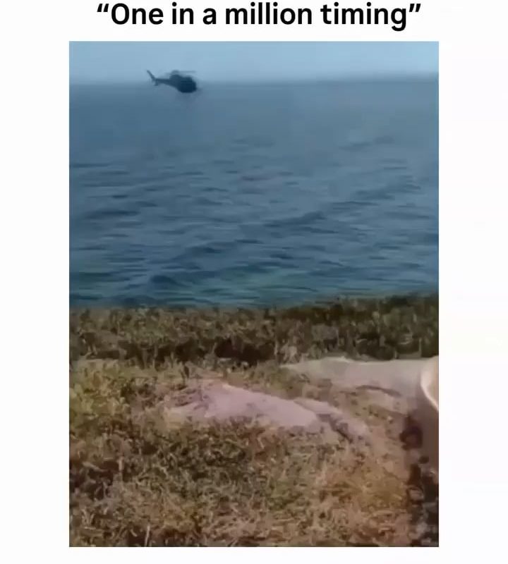 A helicopter pilot decided to pose for a photo with a random guy.