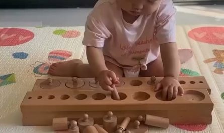 A toddler solving a puzzle by themselves