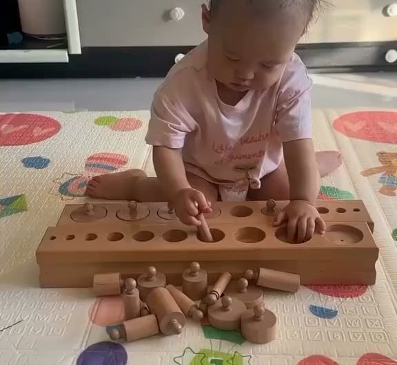 A toddler solving a puzzle by themselves