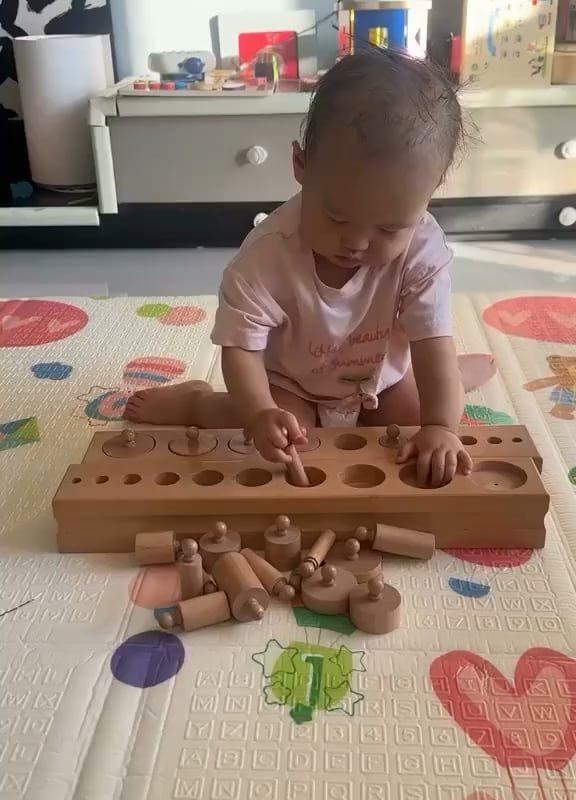 A toddler solving a puzzle by themselves