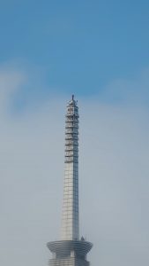 Alex Honnold taking selfies on top of Taipei 101