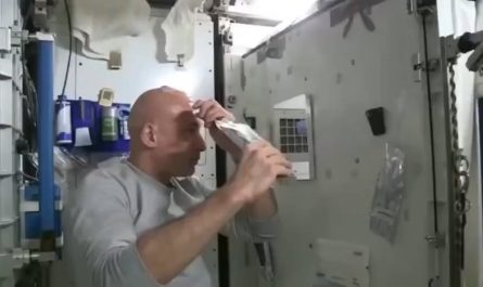 An astronaut washes his hair in space.