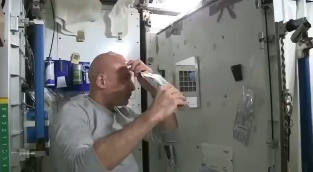 An astronaut washes his hair in space.