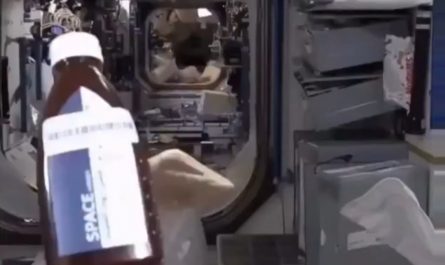 Astronaut eating bread and honey in space.