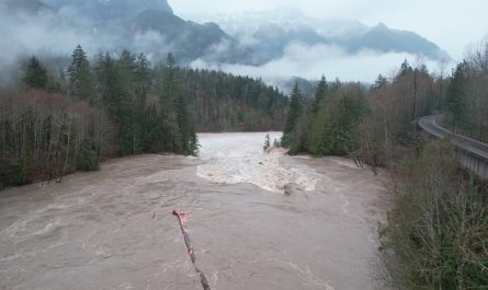 Big log goes over raging waterfall during Washington floods