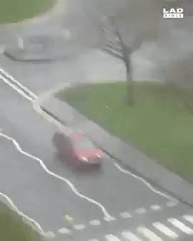 Biker gets off bike in order to help a women cross the street
