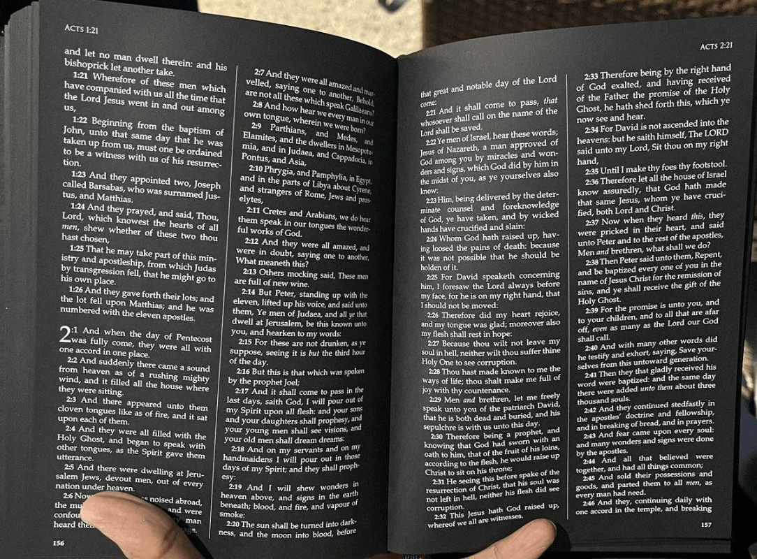 Book printed entirely on black pages giving it a striking appearance.