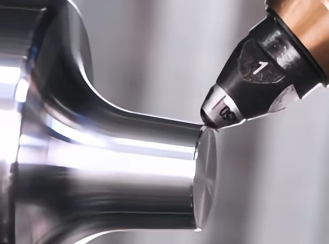 CNC diamond-tipped burnisher polishing a steel tool attachment