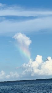 Caught a cloud raining a rainbow onto another cloud