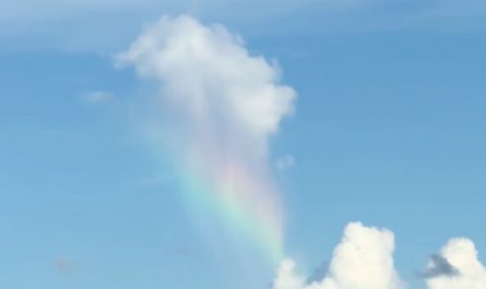 Caught a cloud raining a rainbow onto another cloud