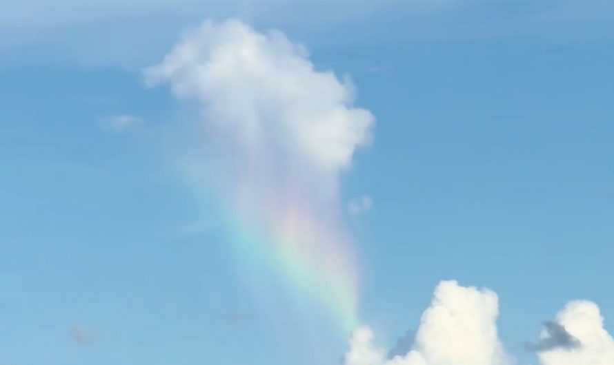 Caught a cloud raining a rainbow onto another cloud