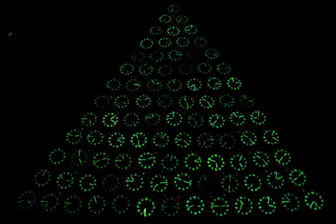 [Christmas tree] Stacked my rare vintage German Wehrle clocks just to see their combined glow. I was stunned to see a 'radioactive' Christmas tree emerge in the dark