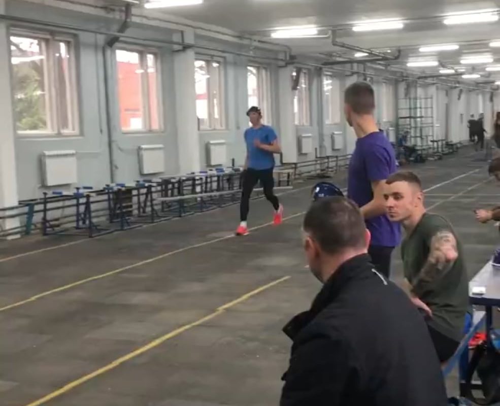 Competitive firefighter climbs up ladder