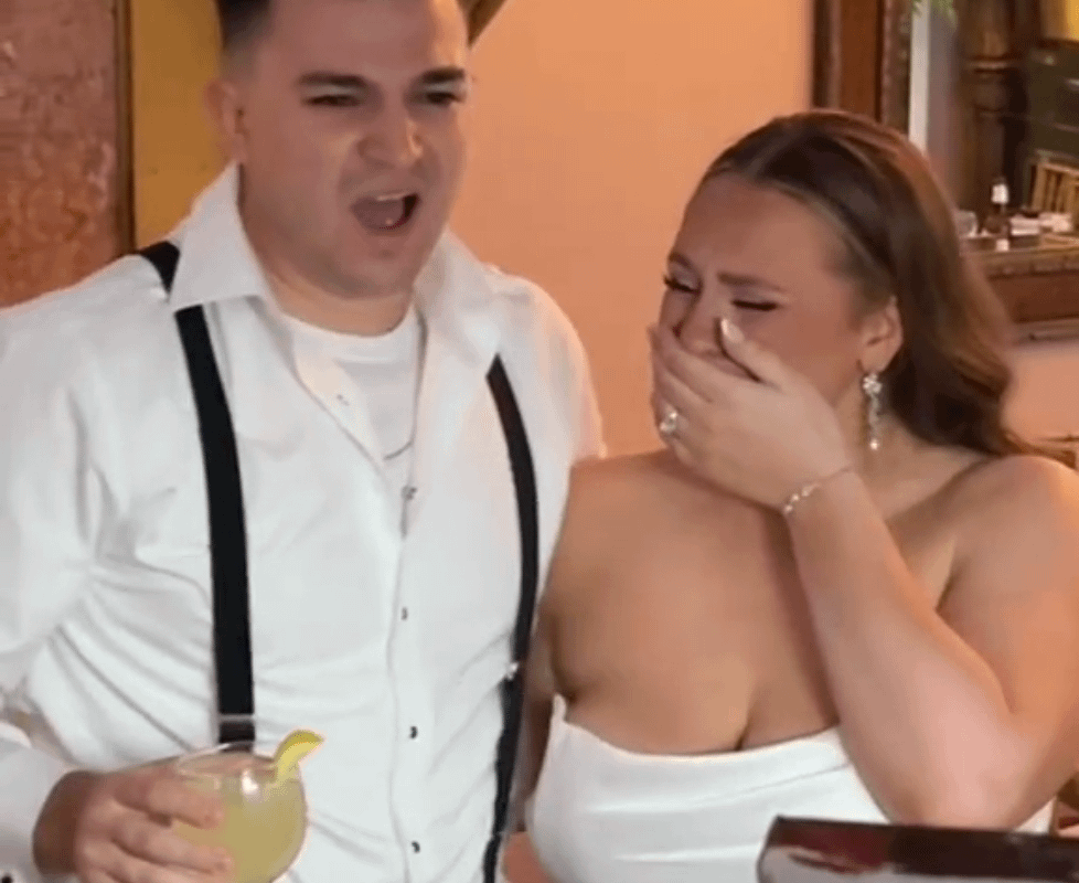 Couple reacts to a painting of them on their wedding day.