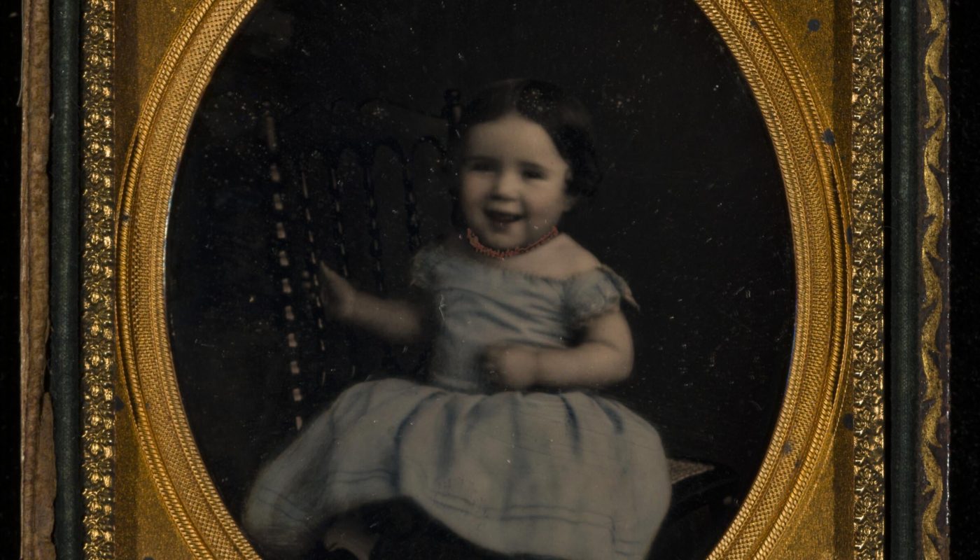 Daguerreotype of a little girl laughing. By this point a photo took 10-15 seconds (not minutes, that is a myth) and could capture some snap shot moments. Photo circa 1850s.
